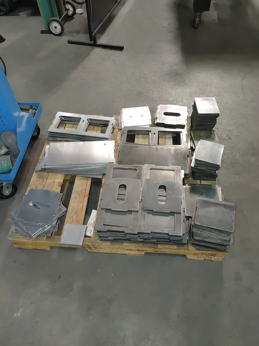 Pallets of freshly cut EmberBox panels, handle slots already pierced.