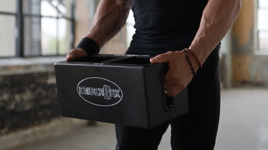 Carrying an EmberBox at the waist with both hands.
