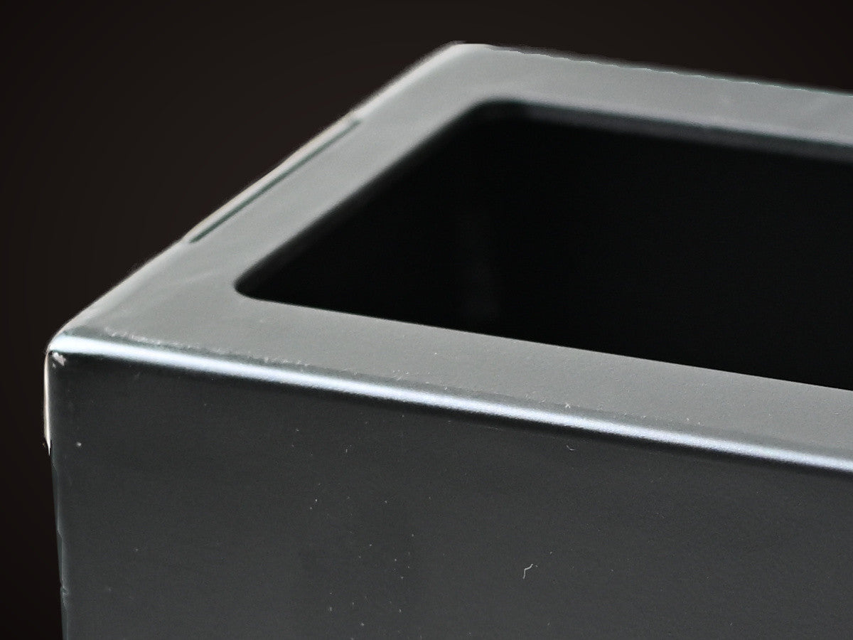 A welded corner of an EmberBox, one hollow core open beside it.
