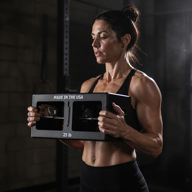 Holding an EmberBox at chest height by both ends.
