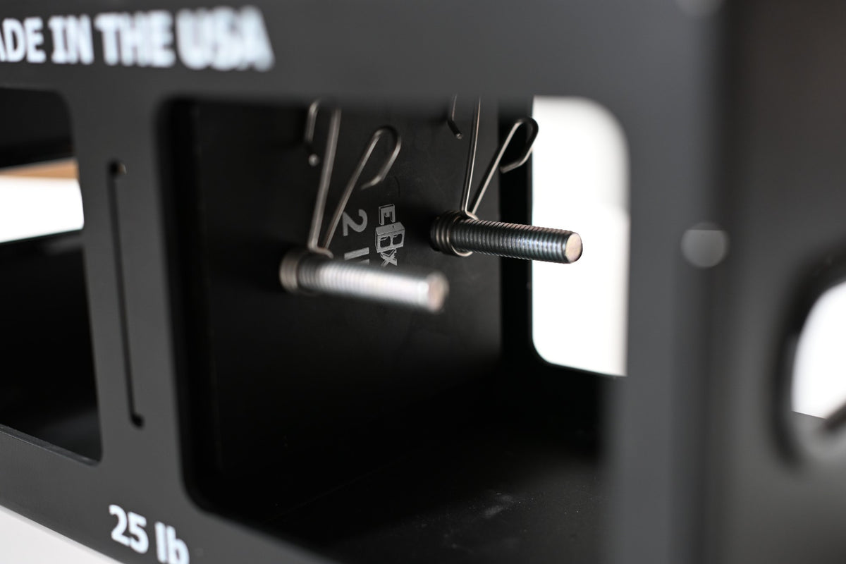 Close on the threaded weight rods and spring clamps inside a core.
