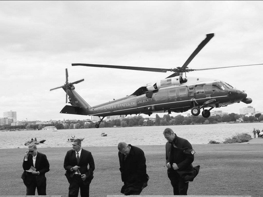 Marine One coming in. The detail waits on the grass.