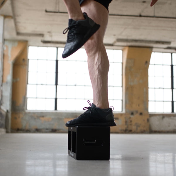 A step-up onto an EmberBox, one foot planted on the steel top.