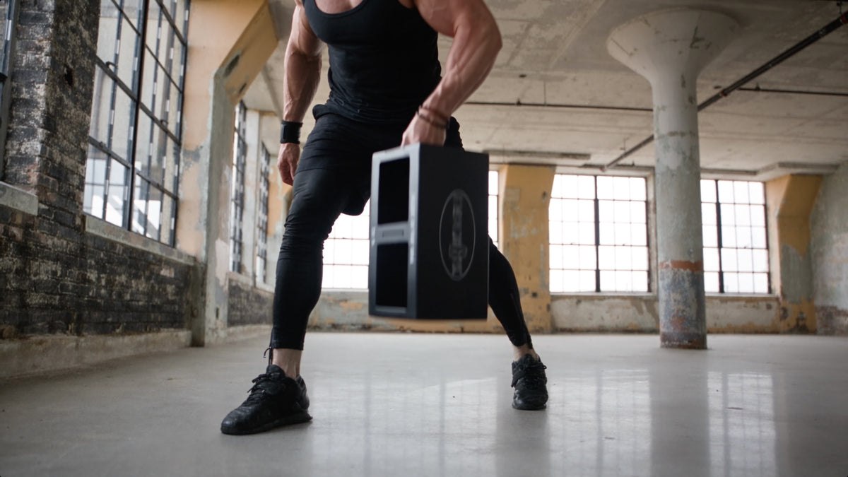 A one-handed carry with the EmberBox low between the legs.