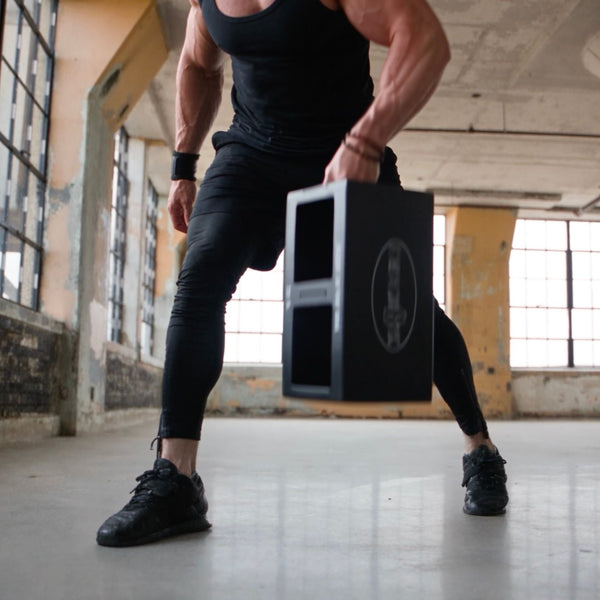 A one-handed carry with the EmberBox low between the legs.