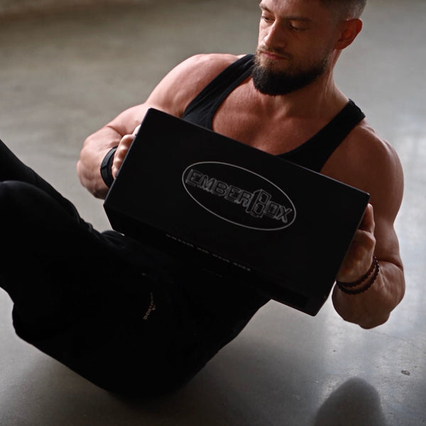 A seated rotation holding an EmberBox, logo forward.